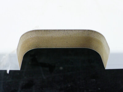 Foil-wrapped MDF postforming edge milled with the LEUCO p-System, chip-free cutter exit.